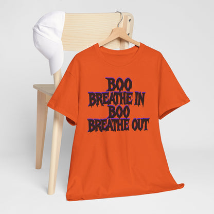 Orange t-shirt with 'BOO BREATHE IN BOO BREATHE OUT' text on a wooden hanger against a white background