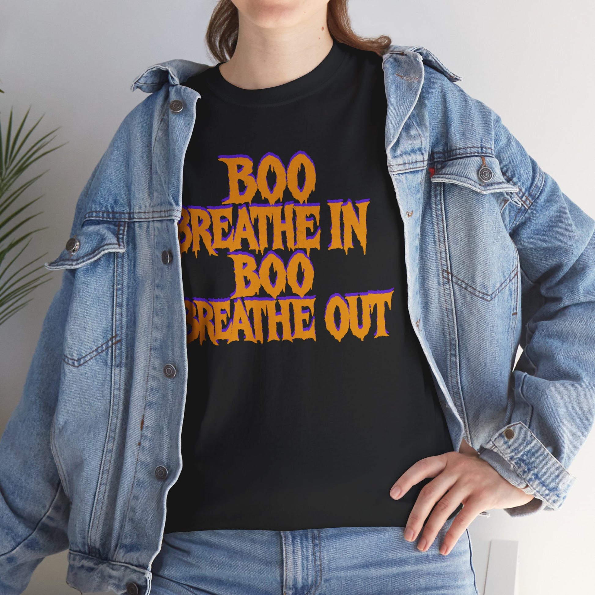 Person wearing a black t-shirt with 'BOO BREATHE IN BOO BREATHE OUT' text, paired with a denim jacket.