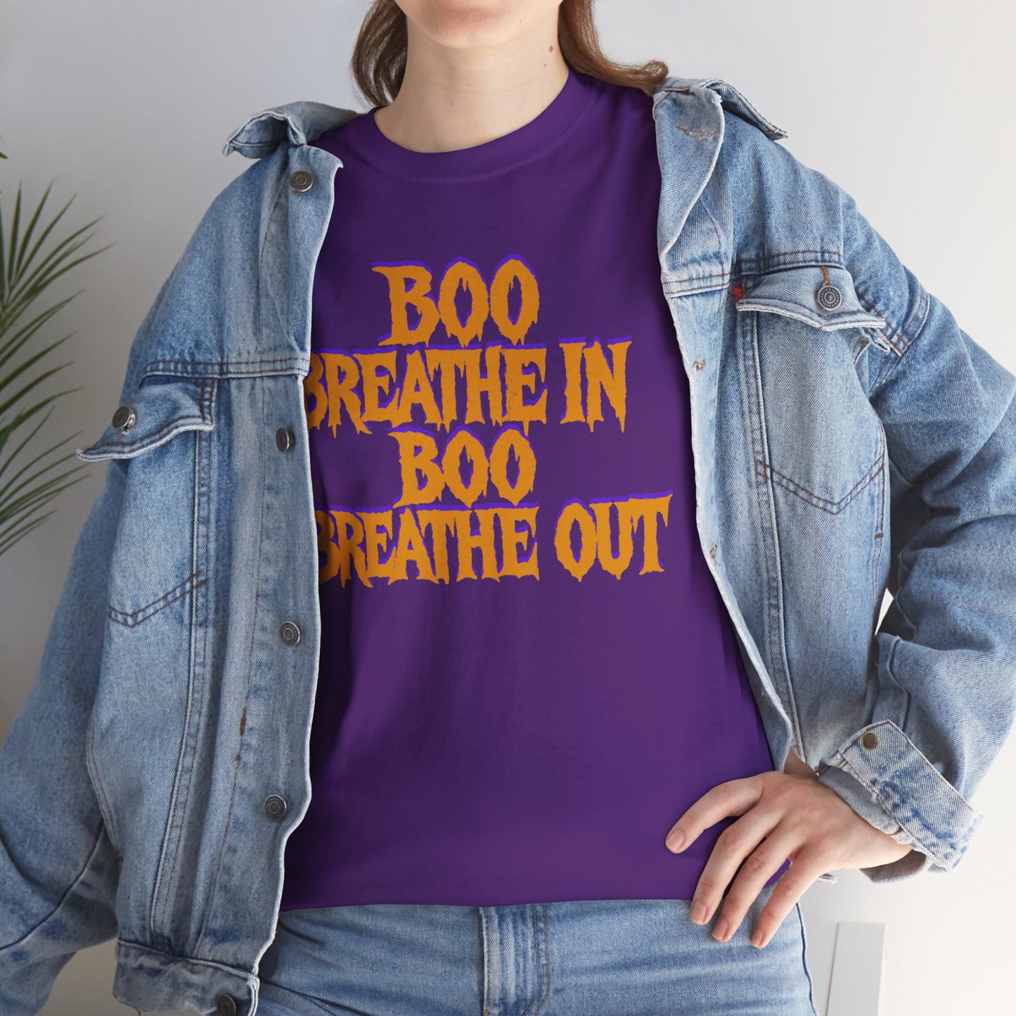Person wearing a purple t-shirt with 'BOO BREATHE IN BOO BREATHE OUT' text, paired with a denim jacket.