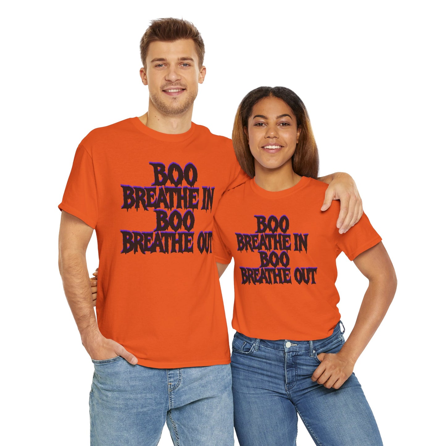 Two people wearing matching orange t-shirts with text on a white background