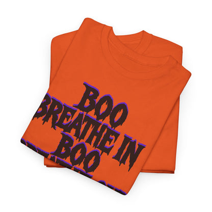 Folded orange t-shirt with 'BOO BREATHE IN BOO' text on a white background