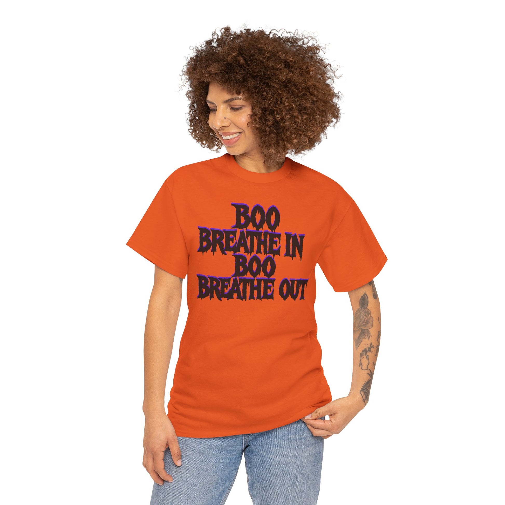 Person wearing an orange t-shirt with 'BOO BREATHE IN BOO BREATHE OUT' text on a white background